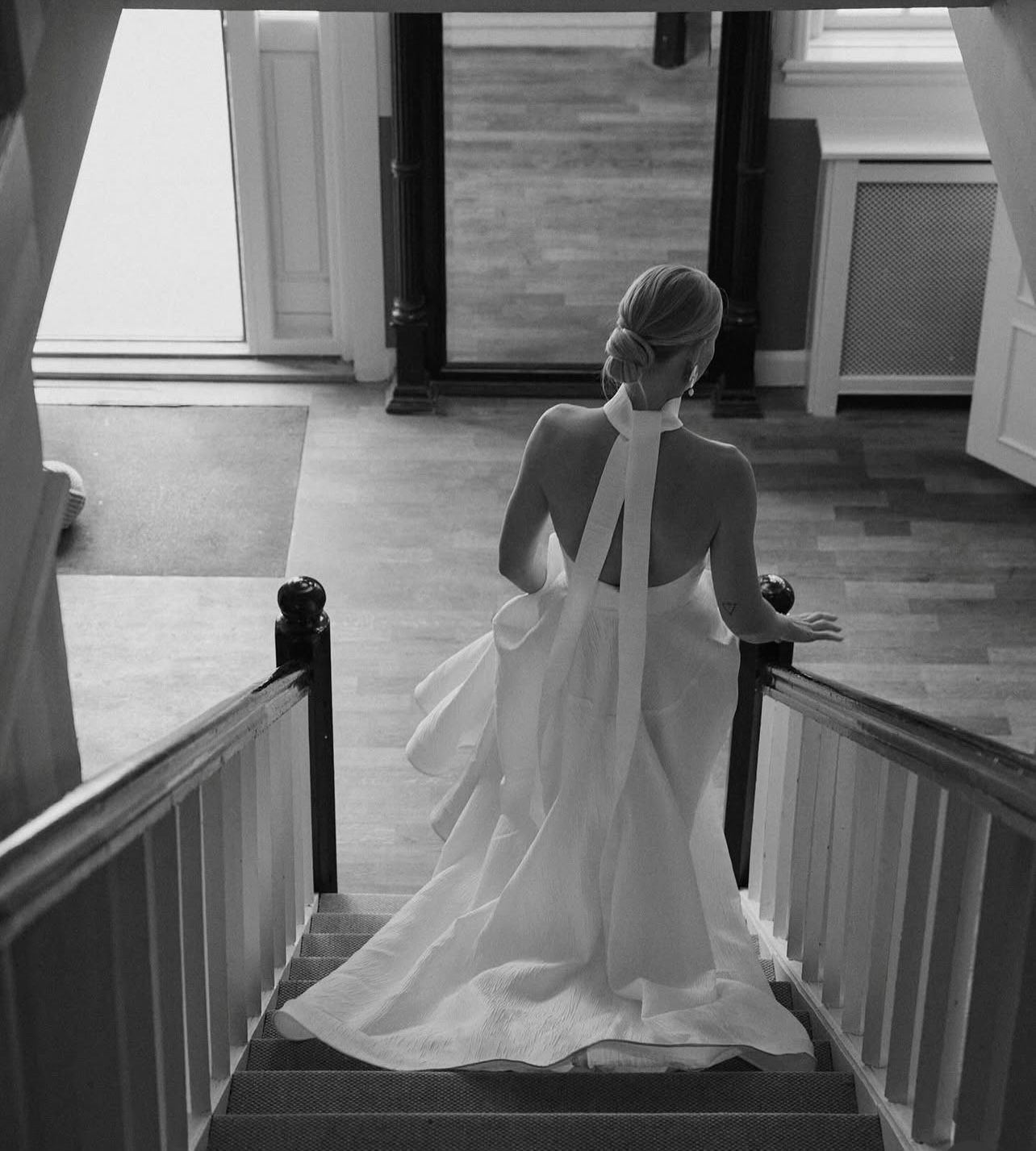 Bride descending the stairs in a flowing couture gown