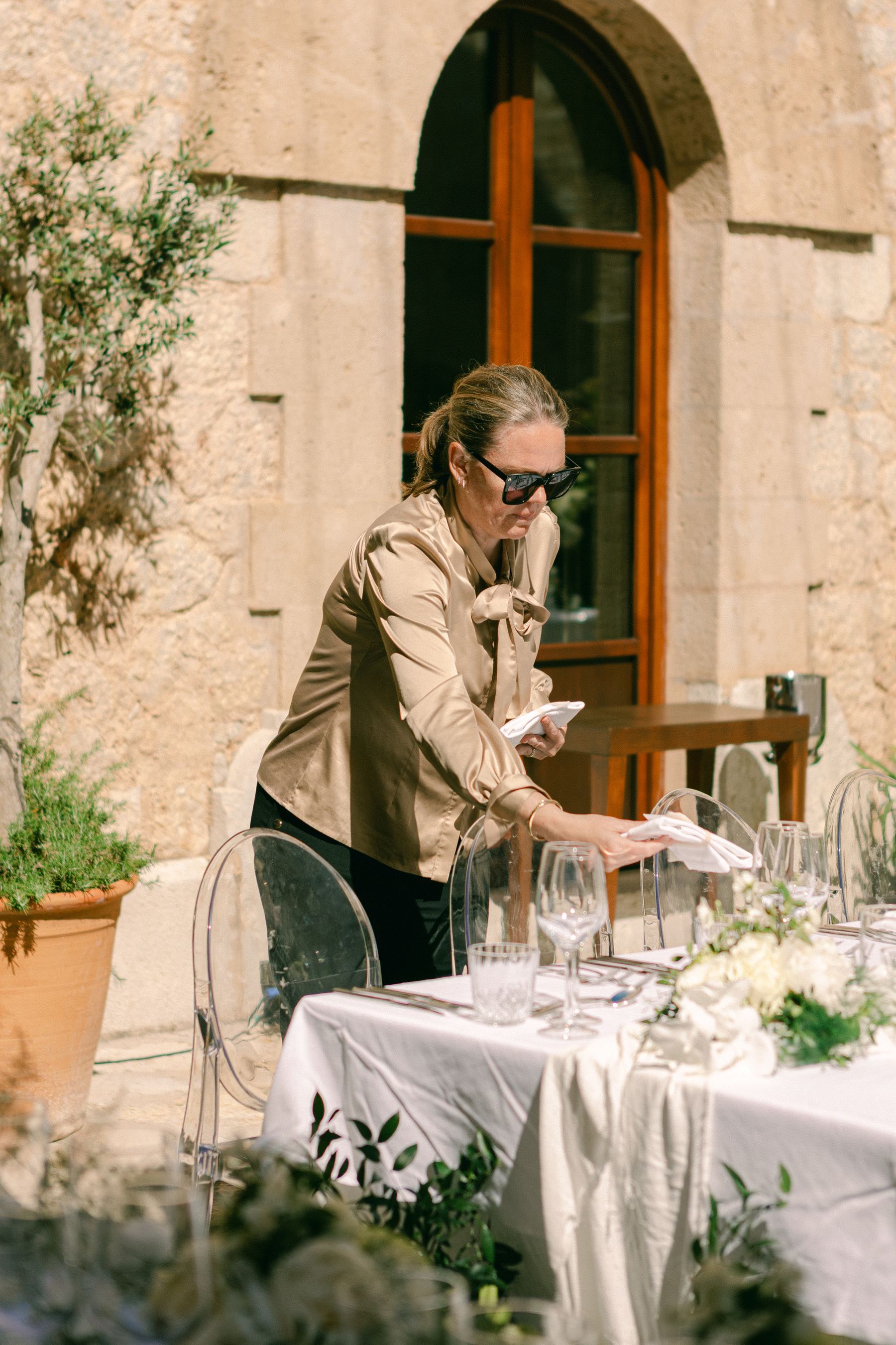Christel perfecting table details at a destination wedding