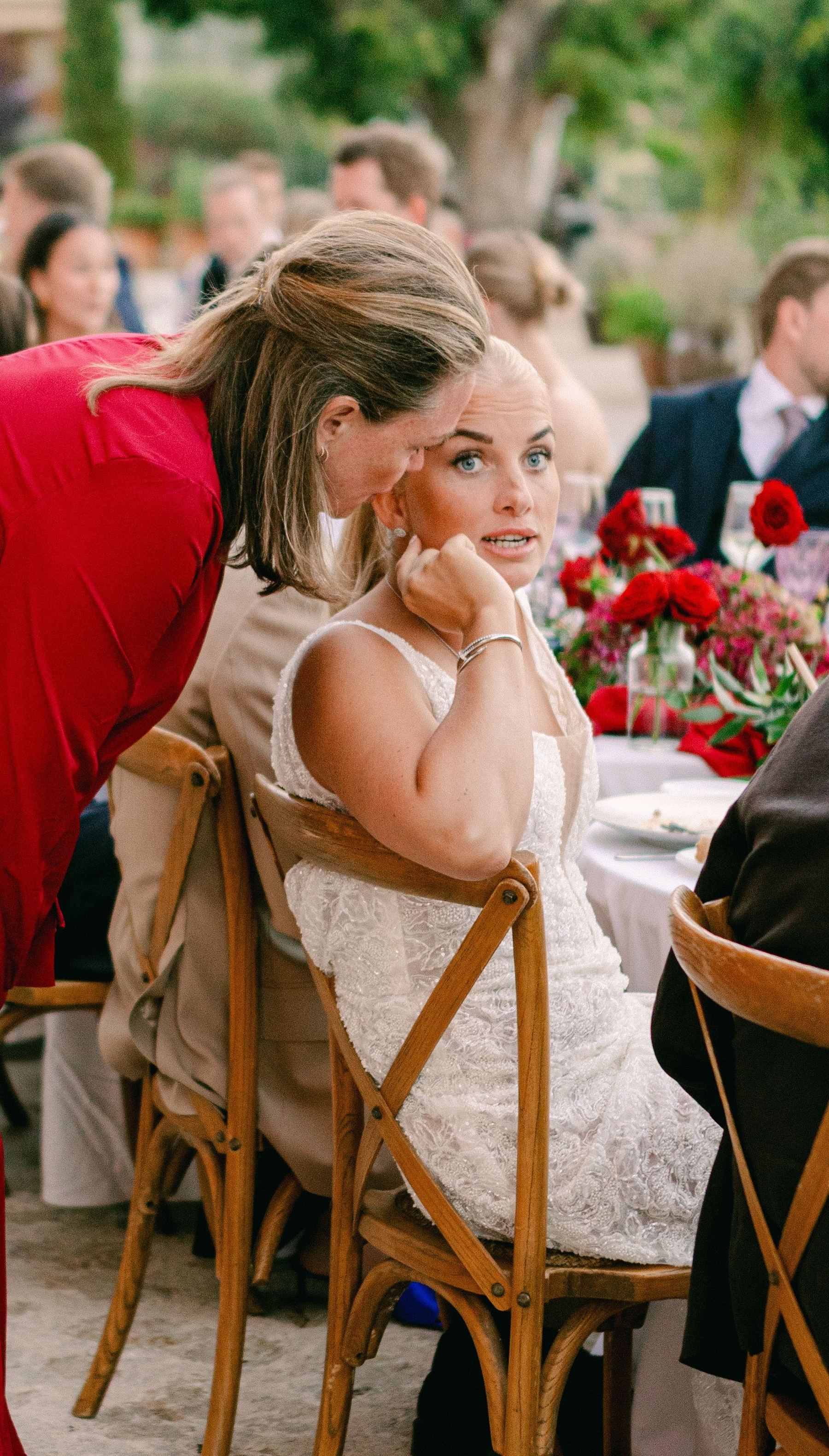 Christel whispering with the bride during the celebration