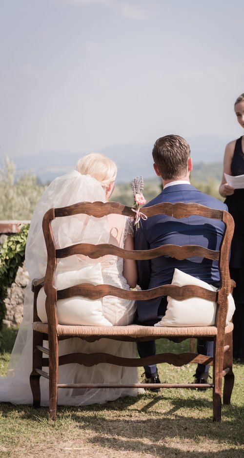 Couple seated during ceremony in Tuscany